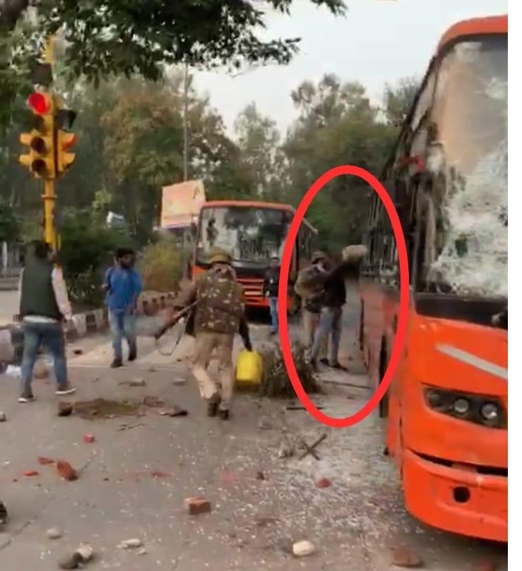 Man pouring petrol in the bus in presence of police