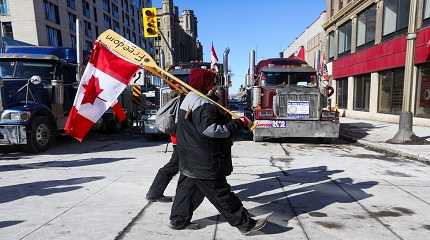 People carry Canadian flags