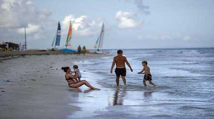 Tourists are seen on beach