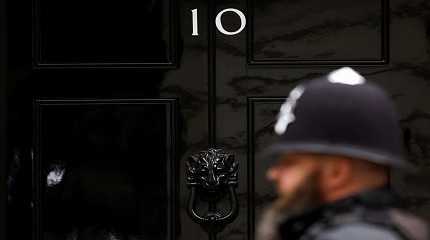 police officer walks past the door of No. 10