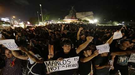 Demonstrators hold slogans