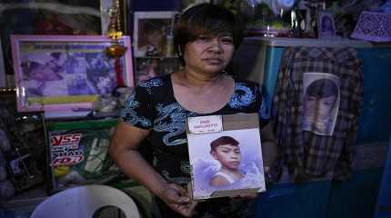 Emily Soriano holds a picture of her 15-year-old son