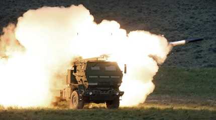 launch truck fires the High Mobility Artillery Rocket System HIMARS