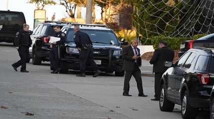 Police investigators work outside the home of Paul Pelosi