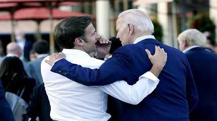 Emmanuel Macron whispers Joe Biden