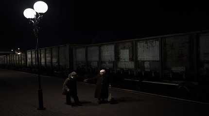 Ukrainian women walk Kherson railway station