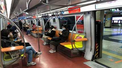 People ride on a subway