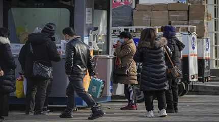 Residents wait in line for their routine COVID-19