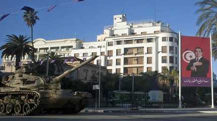 tank is seen next to the portrait of former Tunisian President