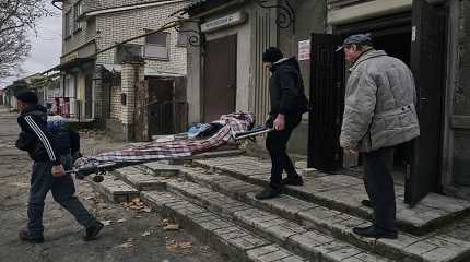 Local residents carry the body