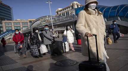 Travelers wearing face masks...