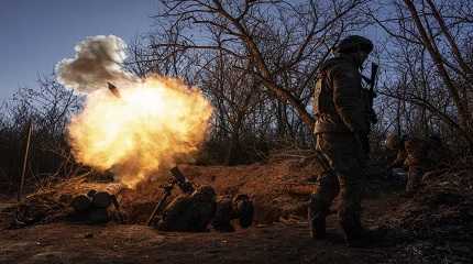 Ukrainian servicemen fire a 120mm mortar 