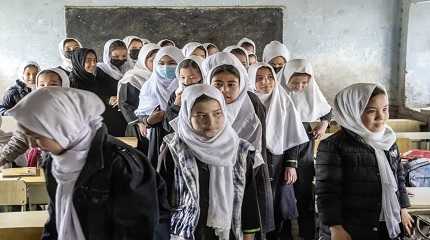 Girls stand in their classroom in Kabul