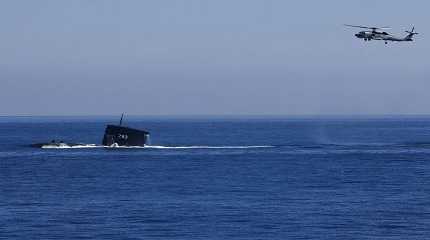 S70C helicopter  flying around SS793 submarine