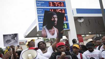 people gather at a gas station