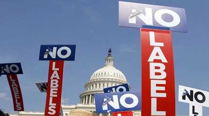 No Labels hold signs during a rally