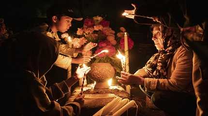 People hold candles