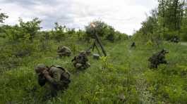 Ukrainian servicemen  legion fire mortars at Russian positions in the eastern region