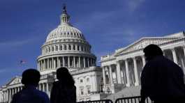 People walk outside the U.S Capitol building