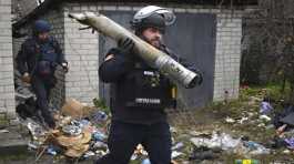 Ukrainian sapper carries a part of a projectile