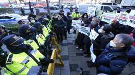 Protesters confront police officers during a rally