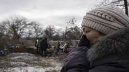 Tamila Pyhyda cries during the exhumation of her husband Serhii Pyhyda