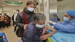 nurse gives a shot of COVID vaccine