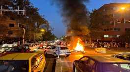 police motorcycle burns during a protest