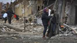 Local residents carry their belongings