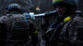 Ukrainian military prepare to fire a mortar round