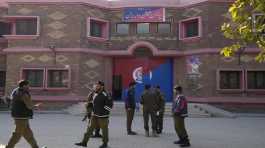 Police officers gather outside a police station