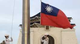 Two soldiers lower the national flag