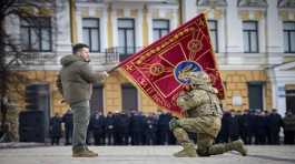 Volodymyr Zelenskyy holds the flag