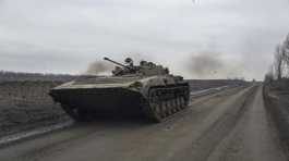 Ukrainian serviceman drives an APC