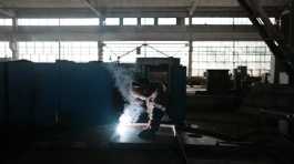 worker welds part of a shelter