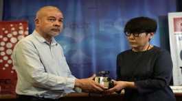 Aye Chan Naing hands over the video camera of slain Japanese journalist Kenji Nagai to his sister Noriko Ogawa