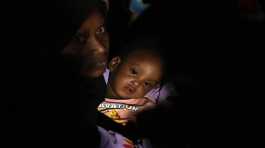 Sudanese evacuees wait before boarding a Saudi military ship