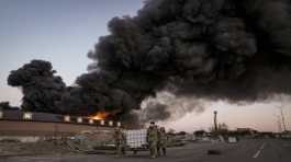 Ukrainian servicemen carry containers